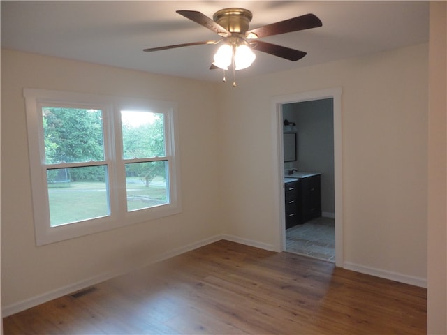 spare room with ceiling fan and dark hardwood / wood-style floors