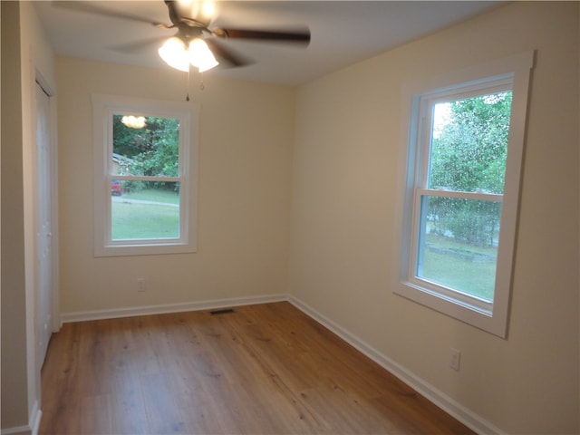 spare room featuring light wood-type flooring and ceiling fan