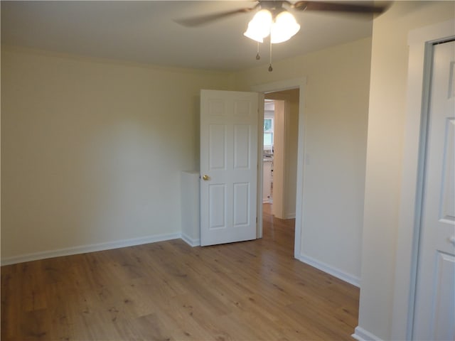 unfurnished room with ceiling fan and light hardwood / wood-style floors