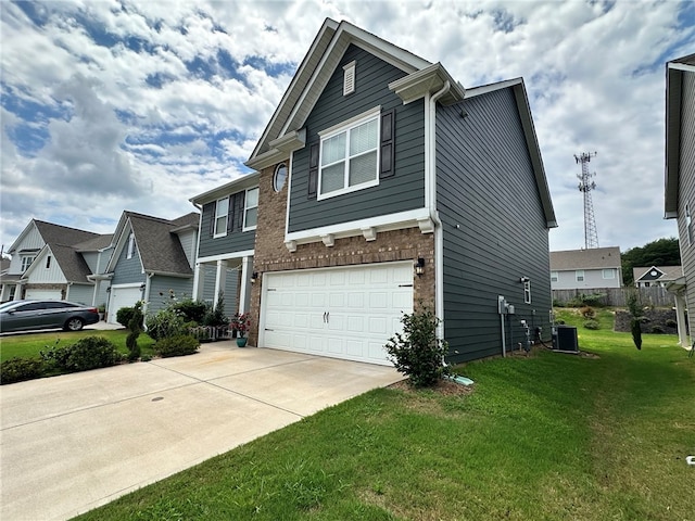 view of front of home featuring a garage, cooling unit, and a front lawn