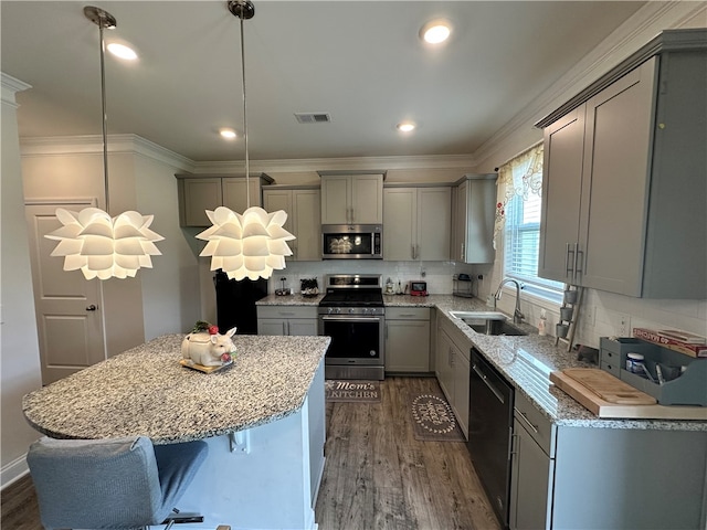 kitchen with pendant lighting, gray cabinets, appliances with stainless steel finishes, and sink