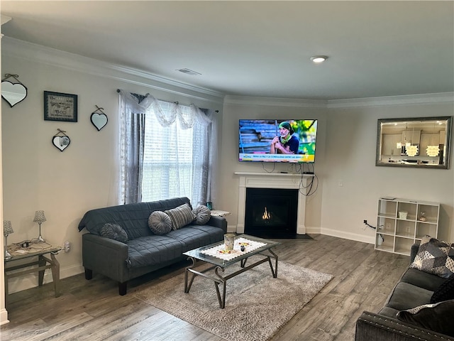 living room with crown molding and hardwood / wood-style flooring