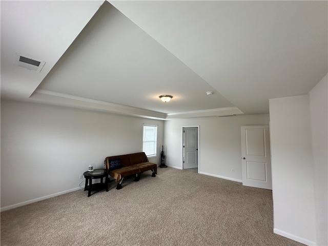 living area featuring carpet floors and a tray ceiling