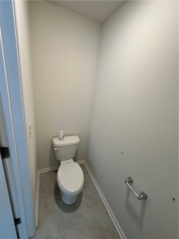 bathroom featuring toilet and tile patterned floors