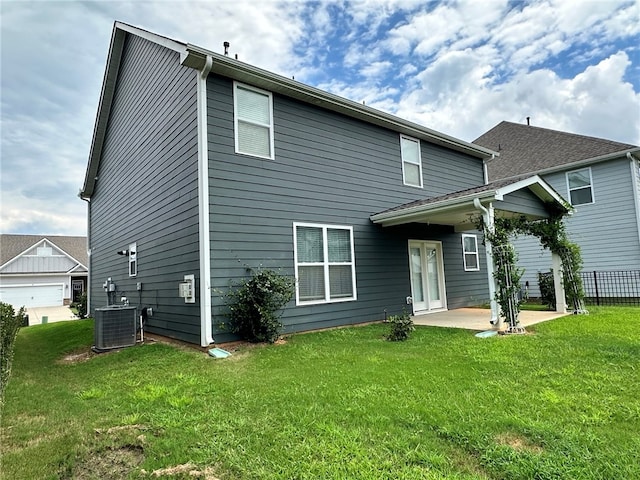 back of house featuring a patio, cooling unit, and a yard