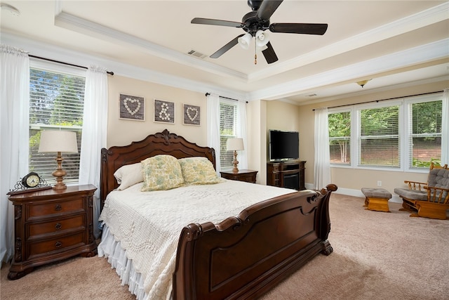 bedroom with multiple windows, a raised ceiling, crown molding, and ceiling fan