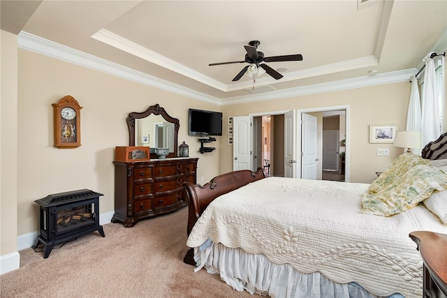 bedroom featuring ceiling fan, light colored carpet, a raised ceiling, and crown molding