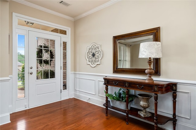 foyer with crown molding and hardwood / wood-style flooring