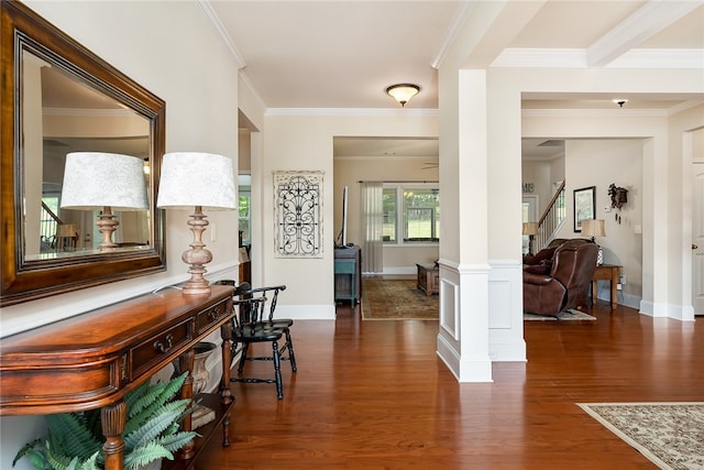 hall with ornamental molding, dark hardwood / wood-style floors, and ornate columns