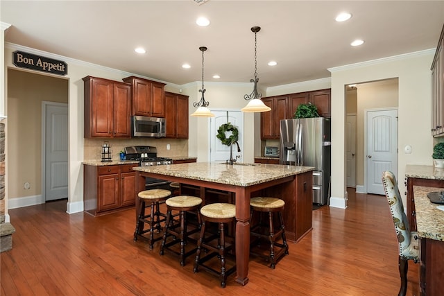 kitchen featuring pendant lighting, dark wood-type flooring, sink, appliances with stainless steel finishes, and crown molding