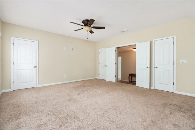 unfurnished bedroom featuring ceiling fan and carpet floors