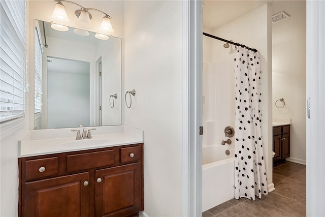 bathroom with shower / bath combination with curtain, vanity, and tile patterned flooring