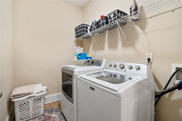 laundry area with washing machine and clothes dryer