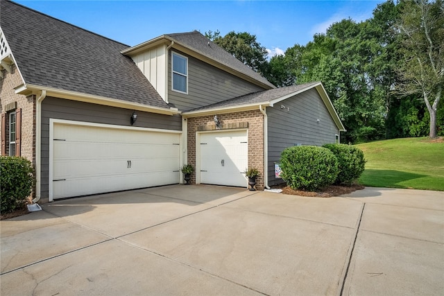 view of home's exterior with a yard and a garage