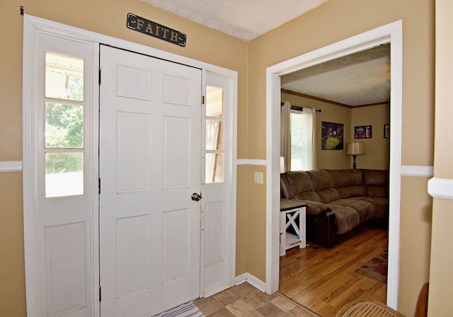 foyer featuring light hardwood / wood-style flooring and a textured ceiling