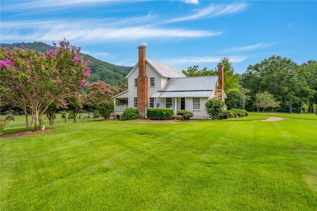 exterior space with a mountain view and a yard