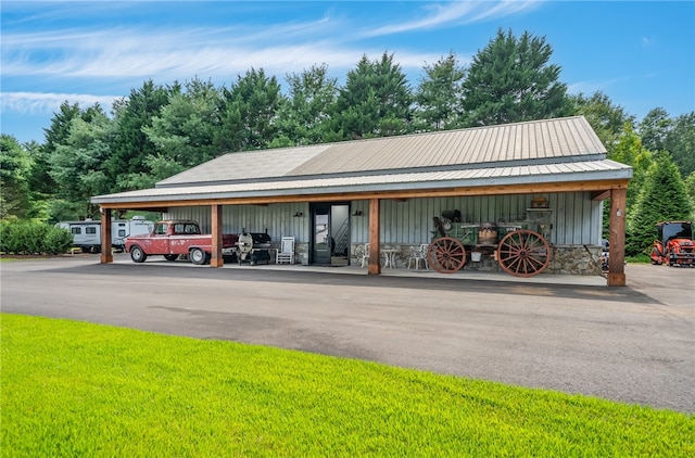 exterior space featuring a yard and a carport