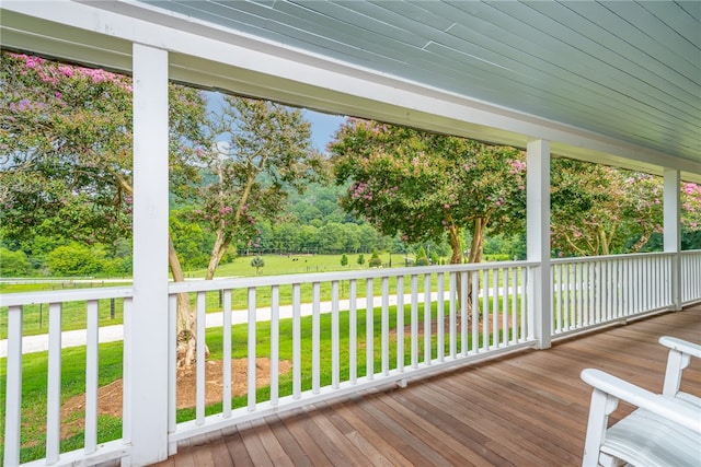 wooden deck featuring a yard