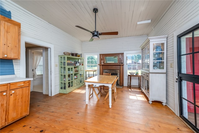 dining area with light wood-type flooring, ceiling fan, and wooden ceiling