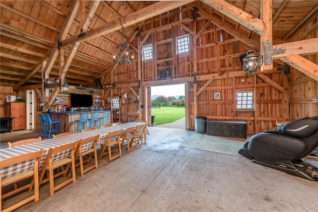 miscellaneous room with a notable chandelier, plenty of natural light, high vaulted ceiling, and wooden ceiling