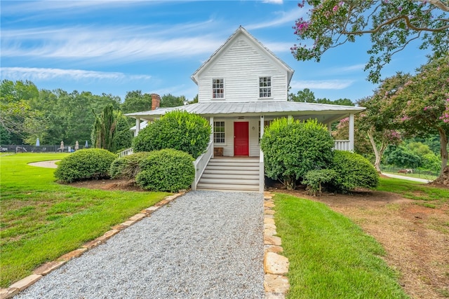 view of front of property with covered porch and a front yard