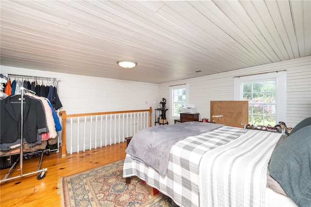 bedroom featuring multiple windows and hardwood / wood-style floors