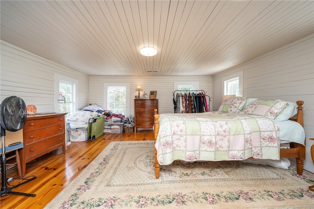 bedroom featuring light hardwood / wood-style floors and wooden ceiling