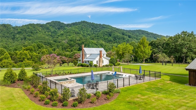 view of pool with a yard