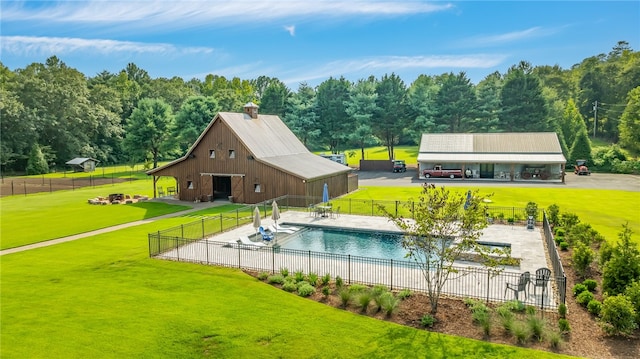 view of swimming pool featuring an outdoor structure and a yard