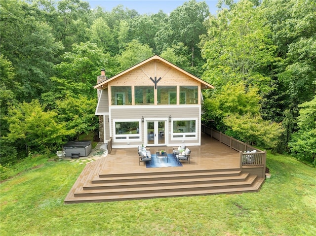 back of property with a wooden deck and a yard