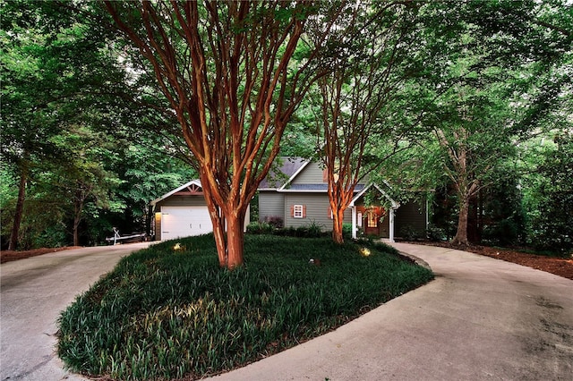 obstructed view of property with a front yard, an outdoor structure, and a garage