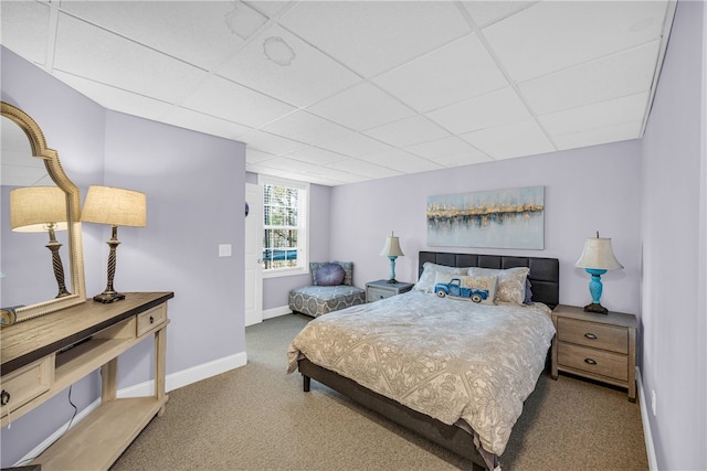 carpeted bedroom with a paneled ceiling