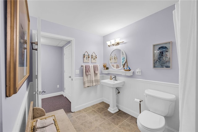 bathroom with toilet and tile patterned floors