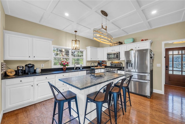 kitchen featuring stainless steel appliances, white cabinets, and plenty of natural light