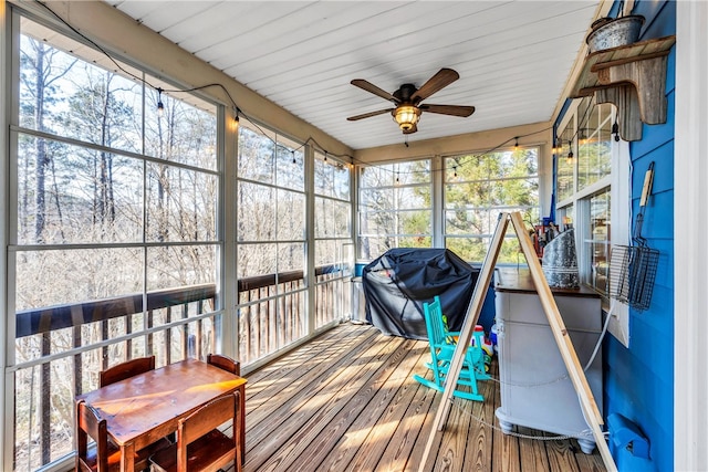 sunroom / solarium with a healthy amount of sunlight and ceiling fan