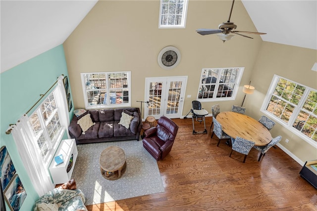 living room with high vaulted ceiling, wood-type flooring, ceiling fan, and french doors