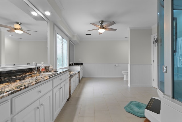 bathroom with ceiling fan, walk in shower, crown molding, toilet, and vanity