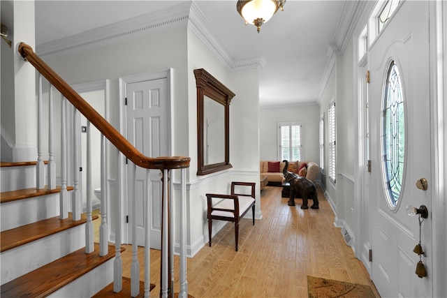 entrance foyer featuring light wood-type flooring and ornamental molding