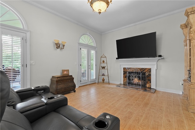 living room featuring ornamental molding, light hardwood / wood-style flooring, and a healthy amount of sunlight