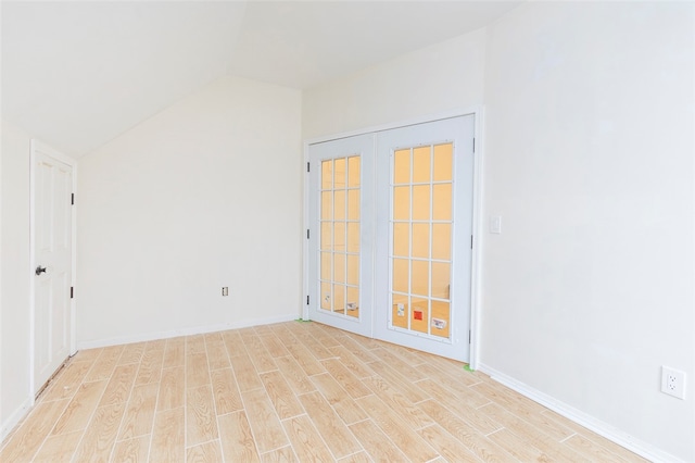 unfurnished room featuring light hardwood / wood-style floors and vaulted ceiling