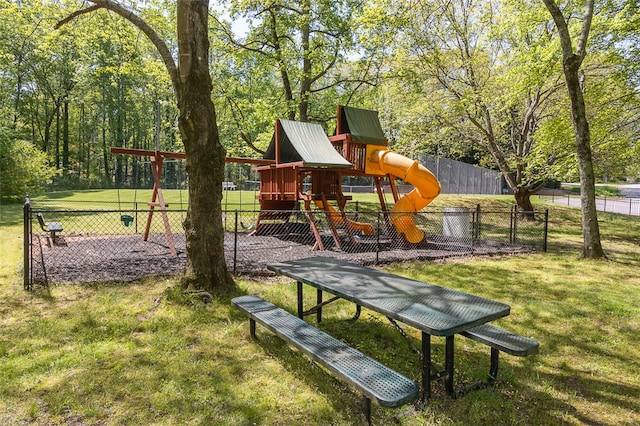 view of home's community with a playground and a yard