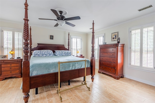 bedroom with light wood-type flooring, multiple windows, ornamental molding, and ceiling fan