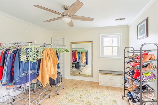 spacious closet featuring ceiling fan and light hardwood / wood-style flooring