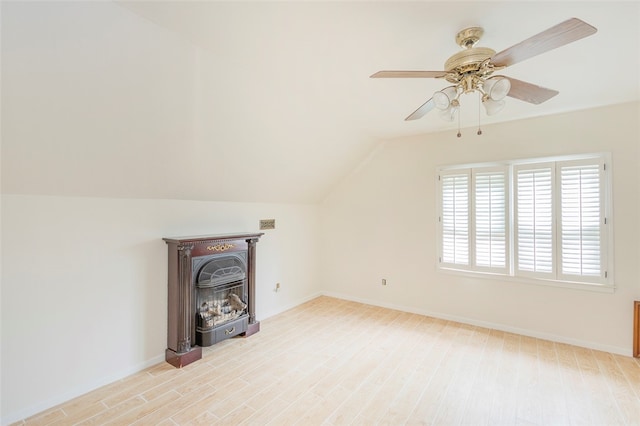 unfurnished living room with ceiling fan, vaulted ceiling, and light hardwood / wood-style flooring