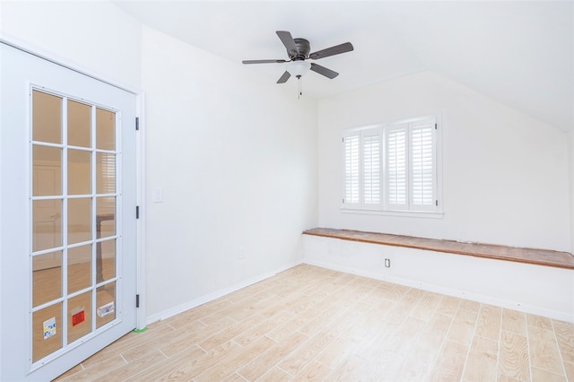 empty room featuring ceiling fan, light hardwood / wood-style floors, and vaulted ceiling