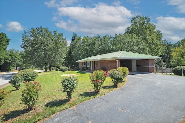 606 N Catherine St, Walhalla, SC 29691 - view of front of home with driveway, brick siding, an attached carport, a metal roof, and view of wooded area