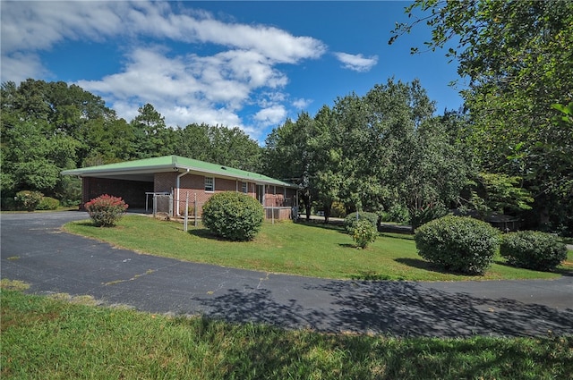 606 N Catherine St, Walhalla, SC 29691 - view of front of home with brick siding, asphalt driveway, a front lawn, and a carport