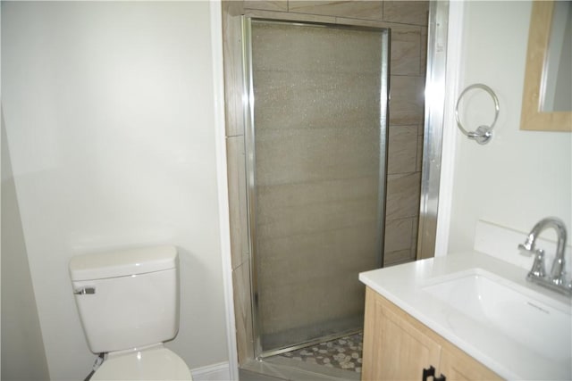 full bathroom featuring a shower stall, toilet, and vanity