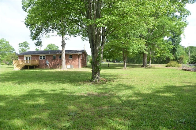 view of yard with a wooden deck