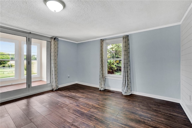 unfurnished room with a textured ceiling, dark hardwood / wood-style floors, and a wealth of natural light